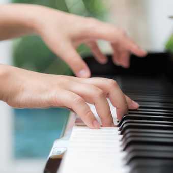 Close up of woman hands  playing piano